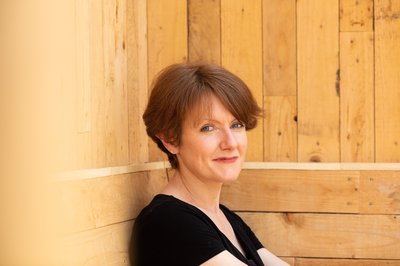 Photo of author Victoria Smith - a white woman with dark brown hair, wearing a black t-shirt.