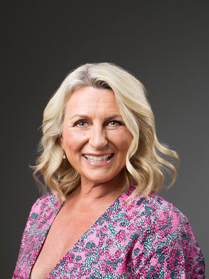 Photo of author Cathy Bramley - a white woman with long blonde hair, wearing a floral top.