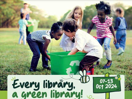 A group of children collecting items on the grass to recycle