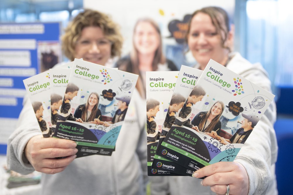 two women holding forwards a copy of an inspire learning brochure