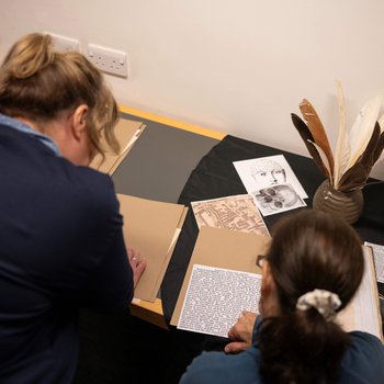 Two people look at historical documents