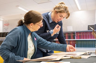 Two people look at historical documents