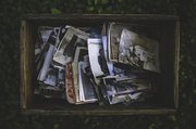 old photographs in a wooden crate