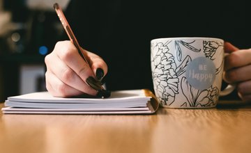 Close up of a person's hand while writing