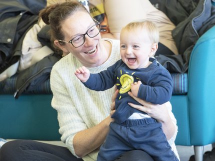 woman holding a child smiling