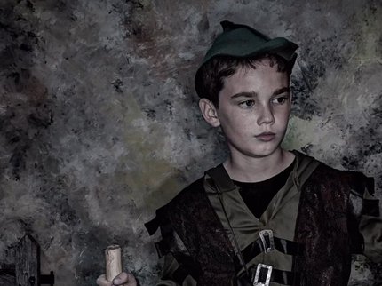 A photography by Alistair Morrison of a young boy wearing a Robin Hood costume