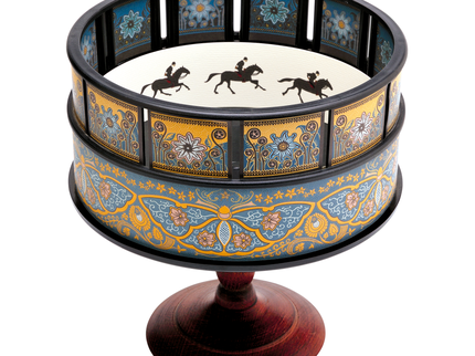 Colour photograph of a zoetrope featuring a figure riding a horse