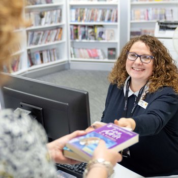 Member of staff serving a customer