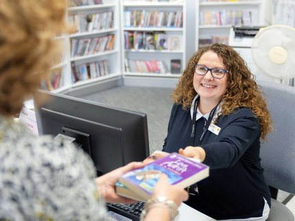 Member of staff serving a customer