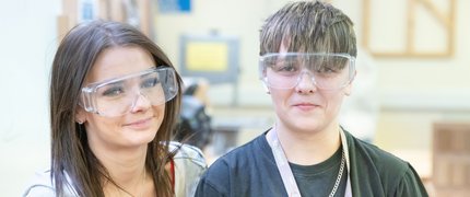 Two Inspire College learners in safety goggles.